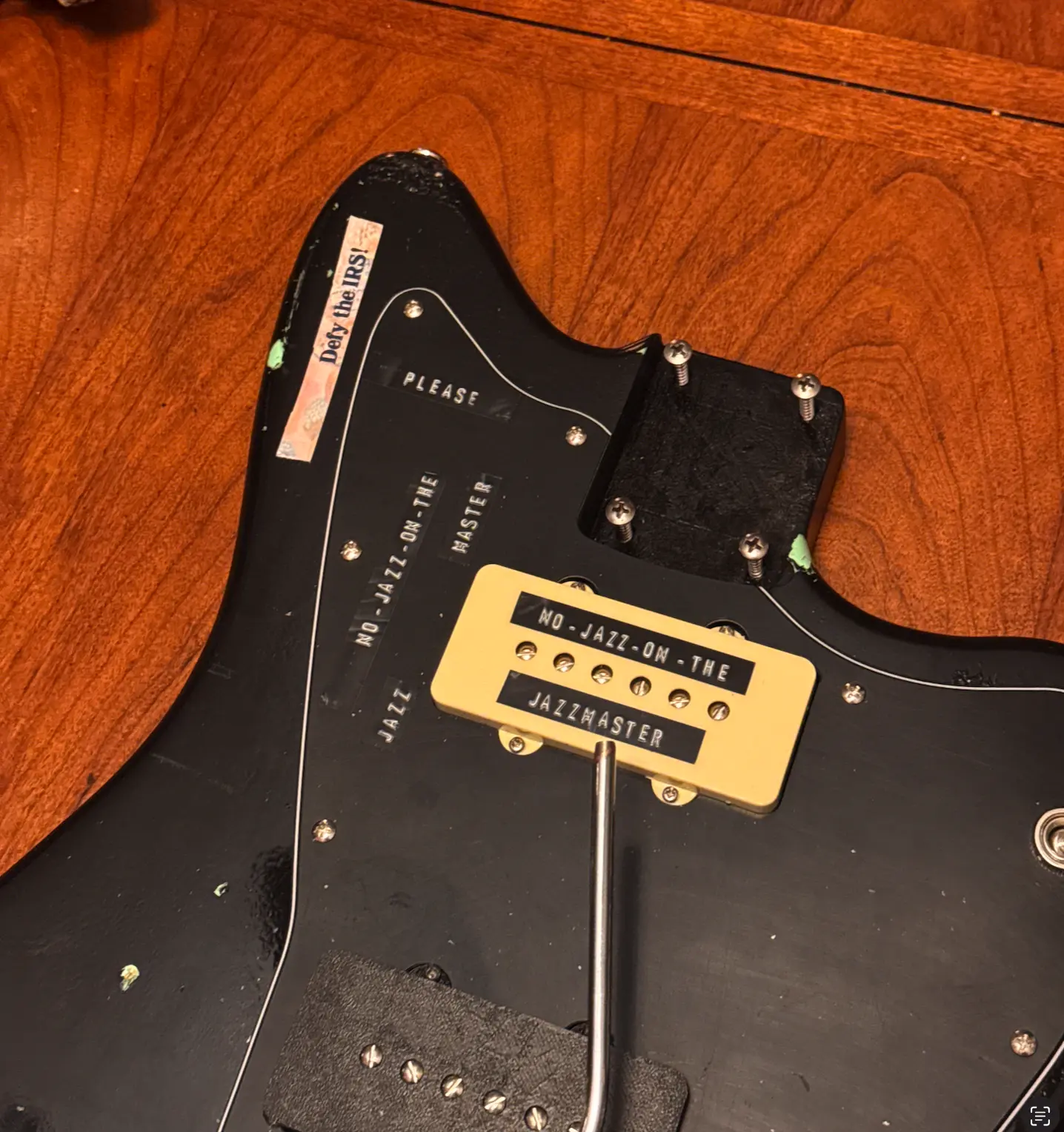 Close-up of custom type labels and the guitar neck plate