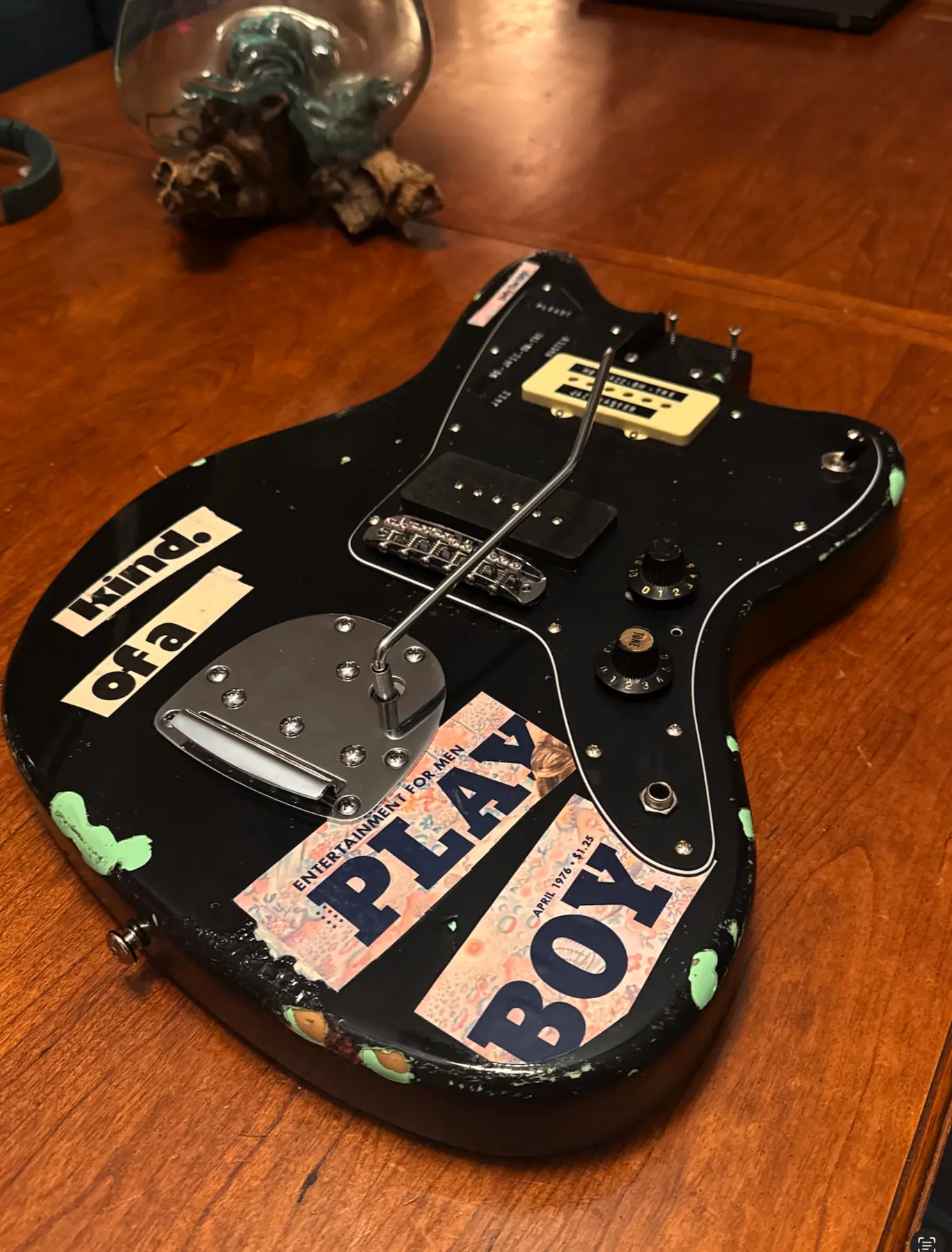 Black transformed guitar with vintage collage lettering and distressed details