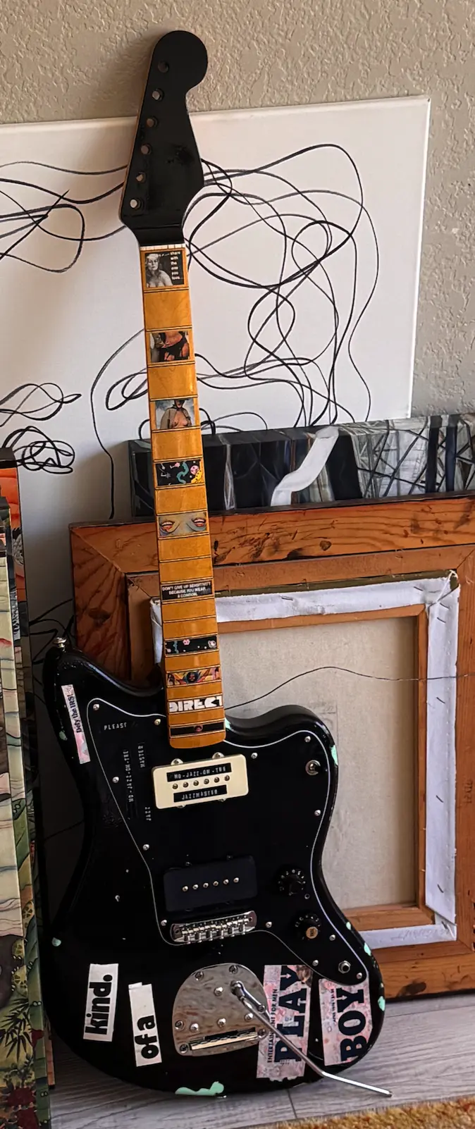 Full view of the finished custom black collage guitar